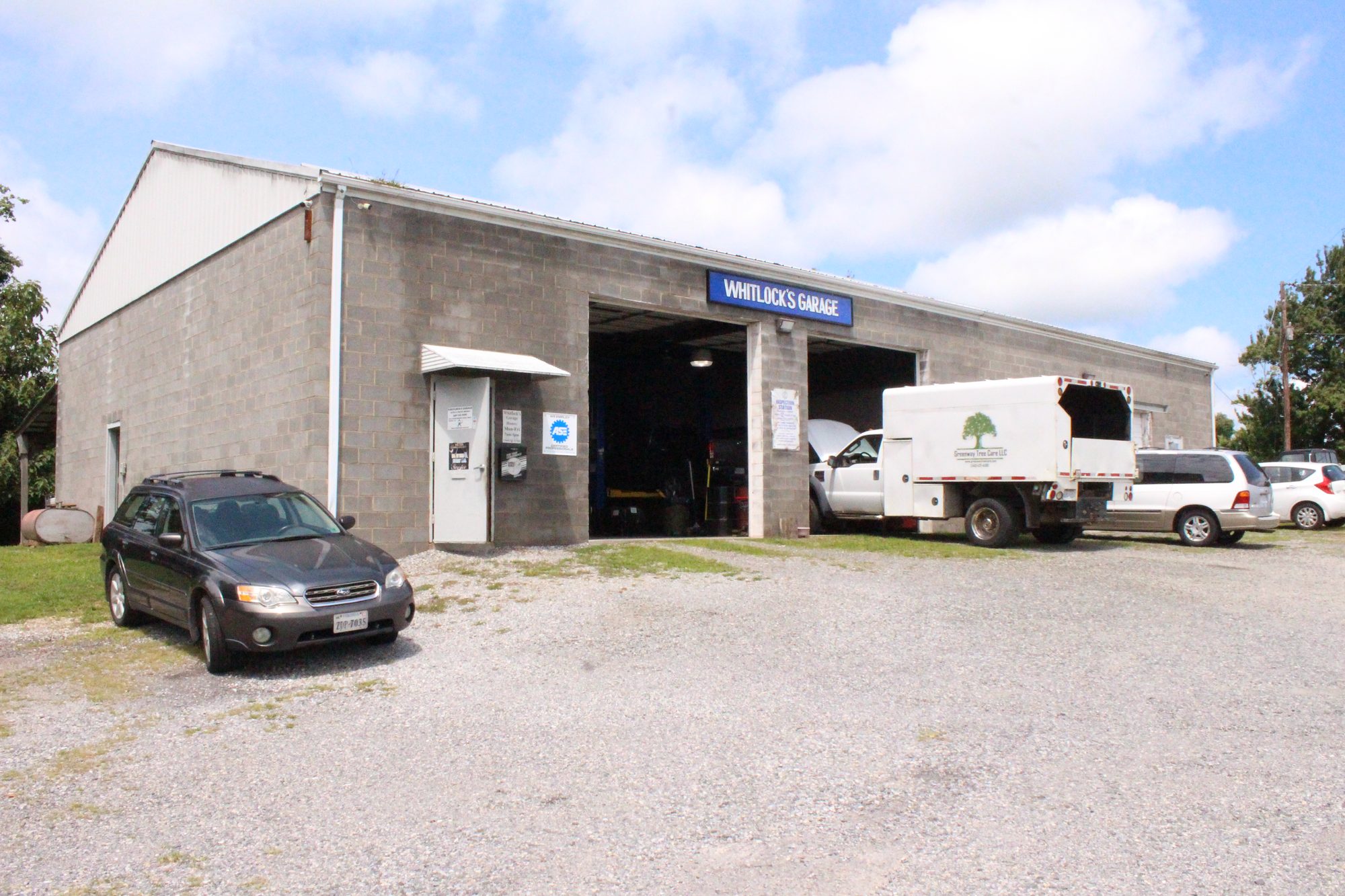 Whitlock’s Garage, a concrete-block shop with open bays on Huckleberry Ridge in Floyd, Virginia
